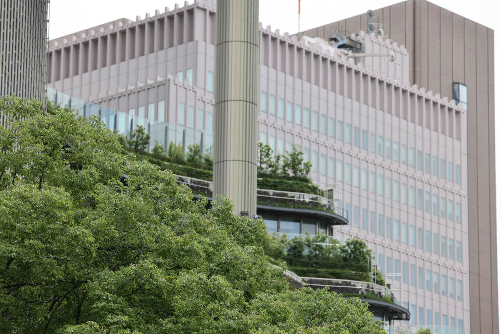 Modern buildings with green terraces and trees
